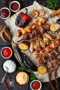Image of a platter of BBQ'd meats and veggies. 