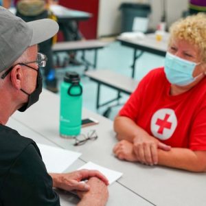 Image of Red Cross volunteers sitting at a table.