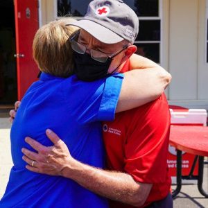 Image of a Red Cross volunteer giving someone a hug.