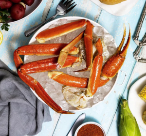 This photo shows Alaskan Snow crab legs served on a plate at a table.