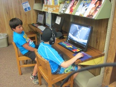 Image of two young boys on computers at the Oakhurst Branch Library.