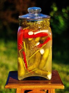 Image of a large jar of pickled cucumbers. 