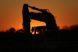 Image of an excavator at night.