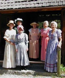 Image of a group of ladies dressed up in vintage dresses.