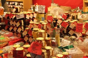 Image of a large selection of jams, jellies, and other preserved foods for sale.