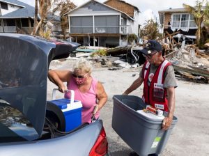 Image of Red Cross volunteers helping out after a hurricane.