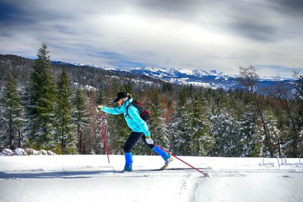 Image of a woman cross-country skiing. 