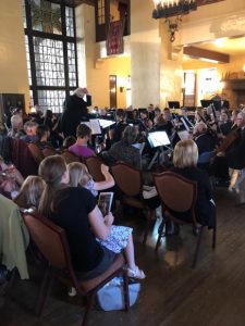Image of a a young audience member learning the art of conducting via observation at a 2019 concert in the Ahwahnee’s Great Lounge (Image by Cheryl Kellogg Petretti).