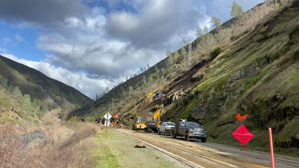 Image of equipment moving debris from rockslide on Hwy 140