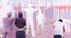 Image of people working on a mural.