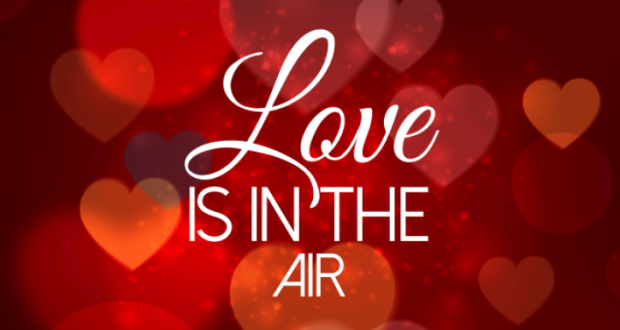 Image of a banner with red hearts and the slogan "Love Is In The Air."