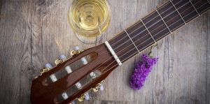 image of a guitar with a glass of wine
