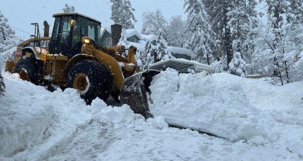 Image of Heavy Equipment Tractor Moving Snow