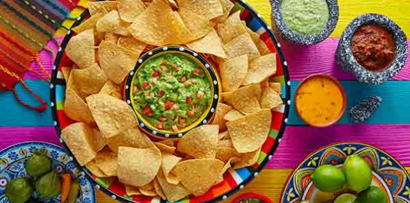 Image of cips in a bowl with salsa and guacamole