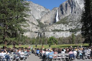 age of people gathering for the law day event in yosemite. Shows yosemite falls in the background