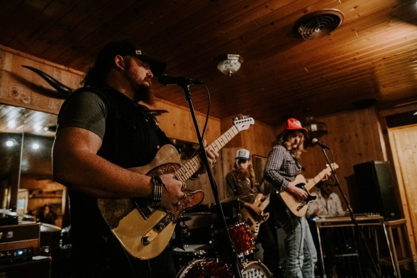 Image of musicians playing on stage at The Snow Line Saloon. 