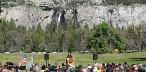 Image of people gathering for the law day event in yosemite. Shows yosemite falls in the background