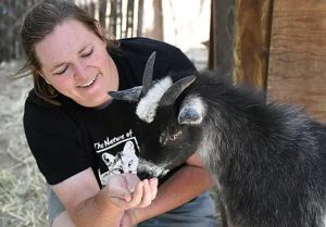 Image of Nicole Wilson and a baby goat. 