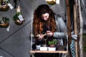 Image of a craftsperson making hanging planters. 