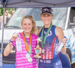 Image of two women with medals after a triathlon.