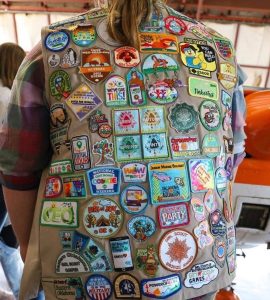 Image of a Girl Scout vest with dozens of patches.