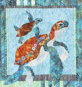 Image of a quilt with a mama turtle and baby.
