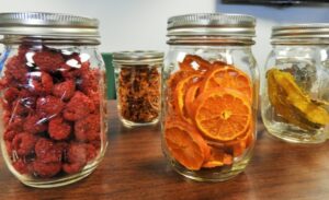 Image of glass jars full of dried fruit. 
