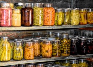Image of a root cellar full of jars of preserved foods. 