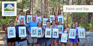 image of people holding up their paintings in yosemite