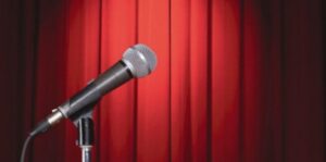 Image of a mic in front of a curtain.