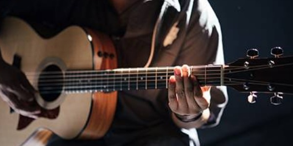 image of a man playing the guitar