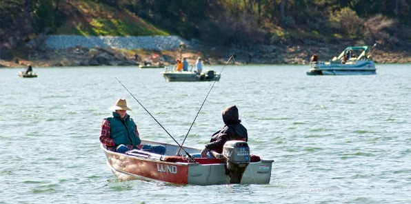 image of someone fishing at bass lake for the fishing derby