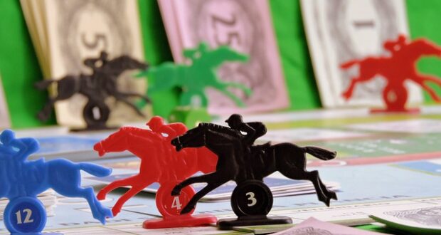 A board game with horse racing figures and money.
