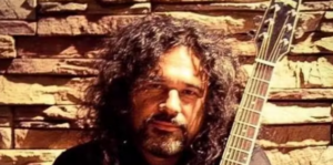 Image of Eddie Guzman with his guitar