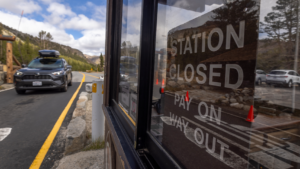 A motorist passes through the Tioga Pass fee station at the eastern entrance to Yosemite National Park, which is vacant of available employees to collect fees that help fund the park on the first day of the government shutdown Oct. 1, 2025. (David McNew/Getty Images)