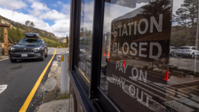 A motorist passes through the Tioga Pass fee station at the eastern entrance to Yosemite National Park, which is vacant of available employees to collect fees that help fund the park on the first day of the government shutdown Oct. 1, 2025. (David McNew/Getty Images)