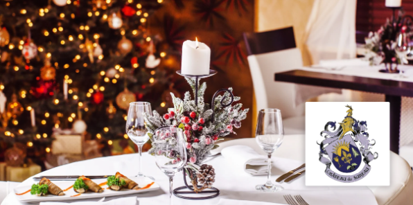 Image of a christmas dinner table with a chritmas tree in the background