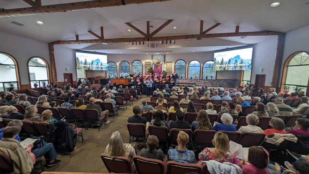 Picture of the interior of Sierra Vista Presbyterian Church, Oakhurst with congregates and choir