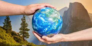 Image of the earth being held with two hands with yosemite in the background