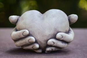 hands holding a sculpted heart