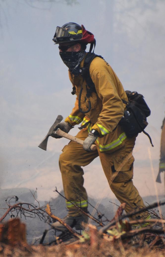 Firefighter with a pulaski - photo by Gina Clugston