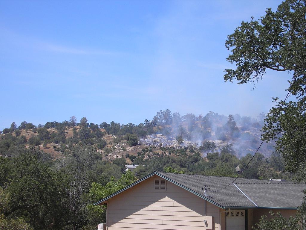 Ranger fire burns up hill behind homes