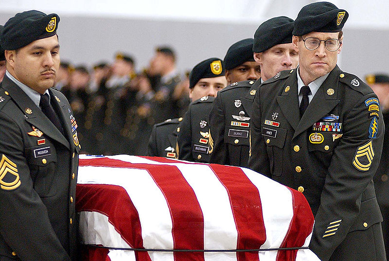 An honor guard from the 1st Special Forces Group transports the flag-draped coffin of Sgt. 1st Class Nathan R. Chapman just before midnight Jan. 8 at Seattle-Tacoma International Airport. More than 60 Green Berets joined the Chapman family at the airport to pay their respects to the first U.S. soldier killed by hostile fire in Afghanistan - Commons