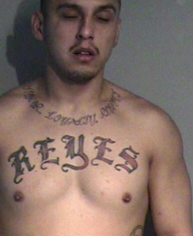 Adrian Joseph Reyes -- HONOR LOYALTY RESPECT -- tattoo just below neckline