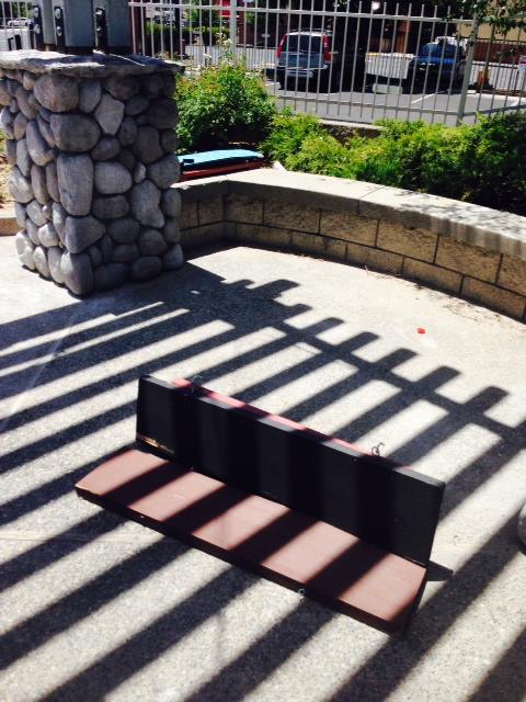 One of the signature carved signs at Junction Center is damaged and left on the ground following vandalism