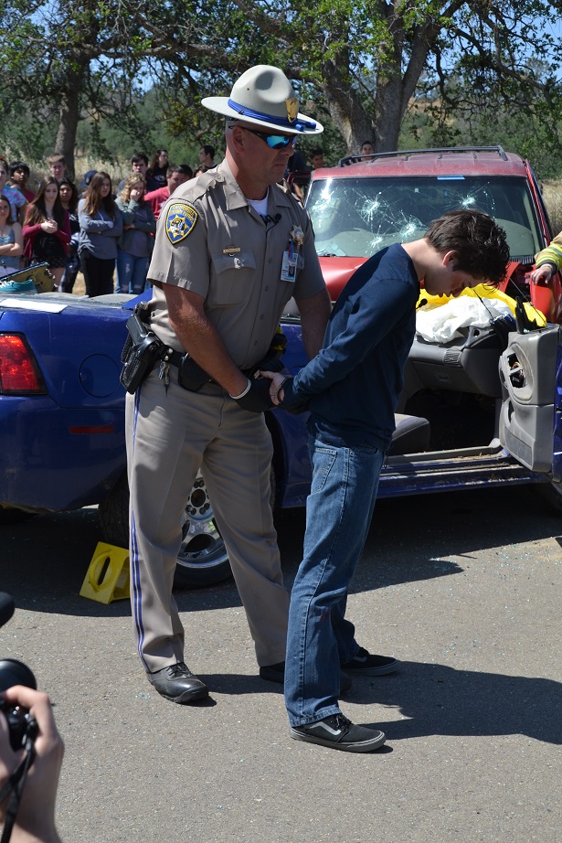 Officer Matyshock places teen driver under arrest - photo by Gina Clugston