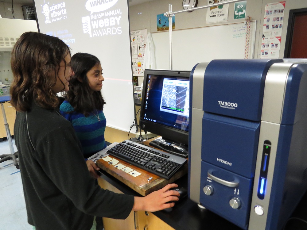 Kat Stanford and Cedar Dobson work with scanning electron microscope - 2014 - photo courtesy Brook Bullock Mountain Home School Charter