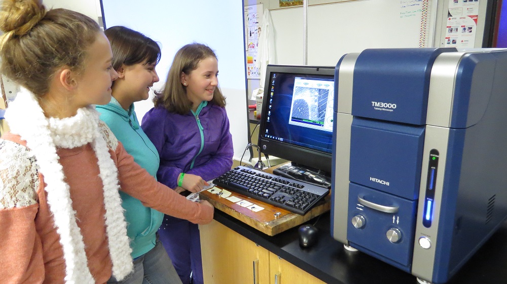 Audrey Phillips, Brianna Kilgore, and Kaylie Sullivan work with the scanning electron microscope on loan at Mountain Home School Charter - 2014 - photo courtesy Brook Bullock Mountain Home School Charter