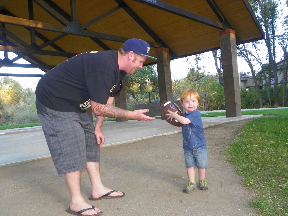 Community Park Sept 2013 - Football at the park with dad Travis and 2 year old son Jaxin - Photo by Kellie Flanagan